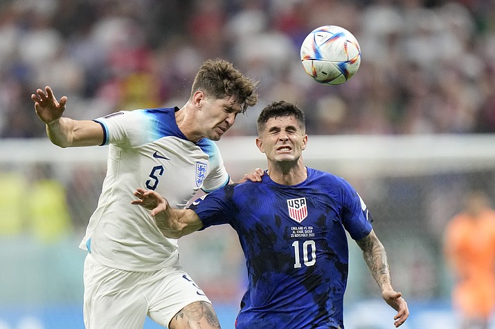 England’s John Stones vies for the ball with Christian Pulisic of the United States, right, during the World Cup group B match between England and The United States, at the Al Bayt Stadium in Al Khor , Qatar, Friday, Nov. 25, 2022. (Luca Bruno/AP)