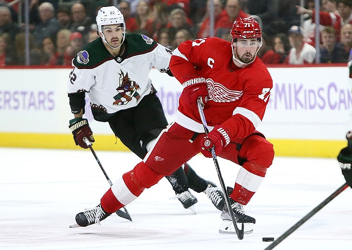 Detroit Red Wings center Dylan Larkin (71) takes the puck past Arizona Coyotes center Jack McBain (22) during the first period of an NHL hockey game Friday, Nov. 25, 2022, in Detroit. (Duane Burleson/AP)