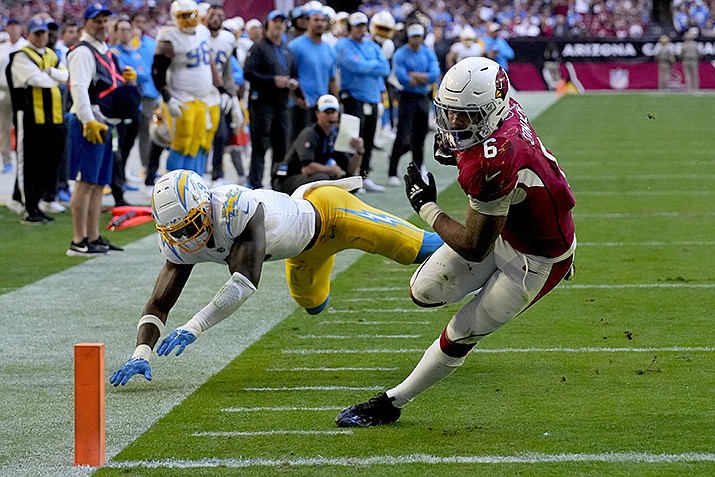 Arizona Cardinals running back James Conner (6) scores a touchdown as Los Angeles Chargers linebacker Kenneth Murray Jr. (9) defends during the second half of an NFL football game, Sunday, Nov. 27, 2022, in Glendale, Ariz. (Rick Scuteri/AP)