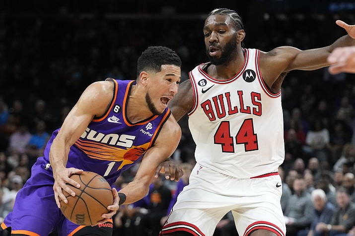 Phoenix Suns guard Devin Booker, left, drives past Chicago Bulls forward Patrick Williams (44) during the first half of a game in Phoenix, Wednesday, Nov. 30, 2022. (Ross D. Franklin/AP)