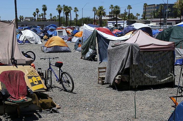 A large homeless encampment is shown in Phoenix, Aug. 5, 2020. On Wednesday, Nov. 30, 2022, the ACLU of Arizona filed a complaint against the city of Phoenix to block the planned resumption of cleanup sweeps it says have displaced people and destroyed identification documents, prescription medications and other meager belongings at a huge homeless encampment downtown. (Ross D. Franklin/AP, File)