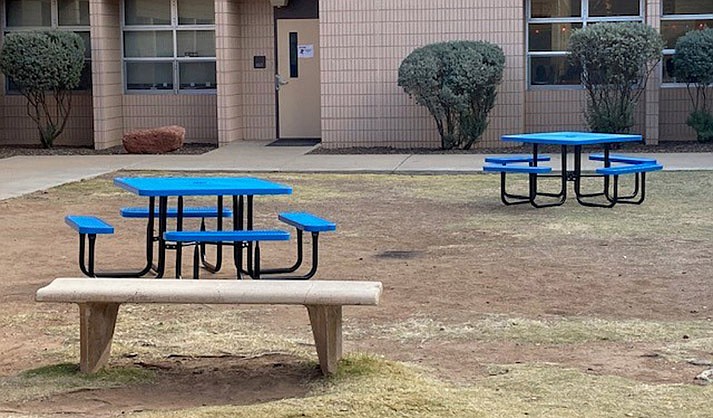 Rubber-coated metallic picnic benches sitting in the courtyard (Photo courtesy of Mark Showers)