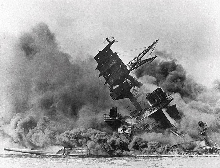Smoke rises from the battleship USS Arizona as it sinks during the Japanese attack on Pearl Harbor, Hawaii, Dec. 7, 1941. The U.S. Navy and the National Park Service will host a remembrance ceremony at Pearl Harbor for the 81st anniversary of the 1941 bombing. (AP Photo/File)