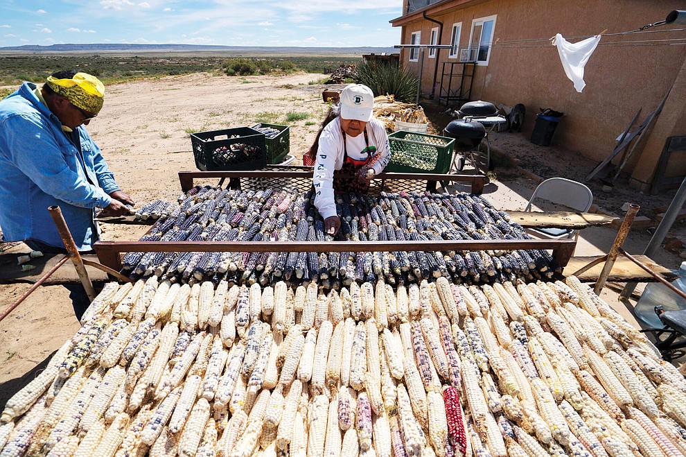 Ann Tenakhongva, 62, and her husband, Clark Tenakhongva, 65, sort traditional Hopi Corn at their home on First Mesa on the Hopi Reservation in Arizona on September 28, 2022. The corn comes from the families’ field in the valley between First Mesa and Second Mesa, which Clark had just harvested. The corn is organized on racks to dry out and then stored in cans and bins for years to come. Much of the corn is ground up for food and ceremonial purposes. Corn is an integral part of Hopi culture and spirituality. (Photo by David Wallace)