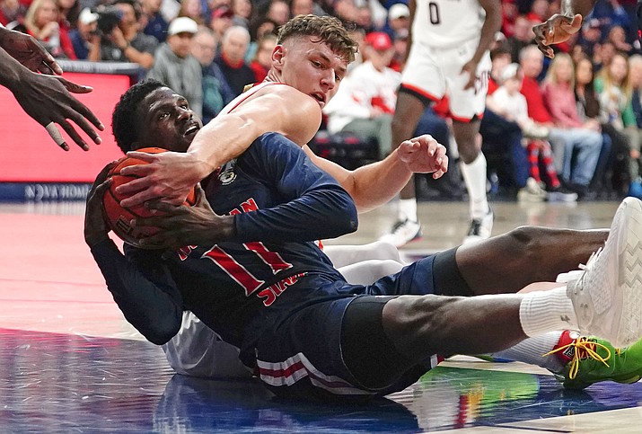 Arizona's Pelle Larsson, right, wraps up Morgan State's Malik Miller, left, as they battle for loose ball during the first half of an NCAA college basketball game, Thursday, Dec. 22, 2022, in Tucson, Ariz. (Darryl Webb/AP)
