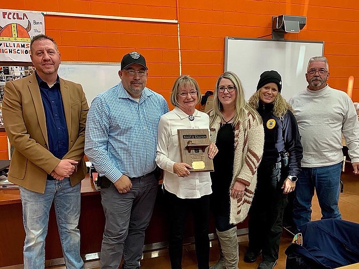 Ann Wells is awarded with a plaque honoring her time served on the WUSD Governing board during the Dec. 15 school board meeting. (Submitted photo)
