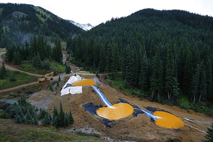 Water flows through a series of retention ponds built to contain and filter out heavy metals and chemicals from the Gold King Mine. The U.S. government settled a lawsuit Wednesday, Aug. 5, 2020, brought by the state of Utah over a mine waste spill caused by federal workers that sent wastewater downstream to several states from the inactive Gold King Mine in southwestern Colorado five years ago. The Environmental Protection Agency agreed to fund $3 million in Utah clean water projects. (AP Photo/Brennan Linsley, File)