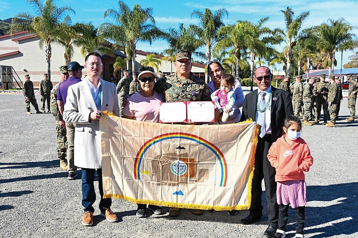 Council Delegates Carl Slater and Pernell Halona present Marine Sgt. Alecsaiah Tree a Navajo Nation Flag during the Purple Heart Ceremony at the Marine Corps Base Camp Pendleton in California. Sgt. Tree's mother, sister and nieces were also in attendance.  (Photo/Navajo Nation Council)