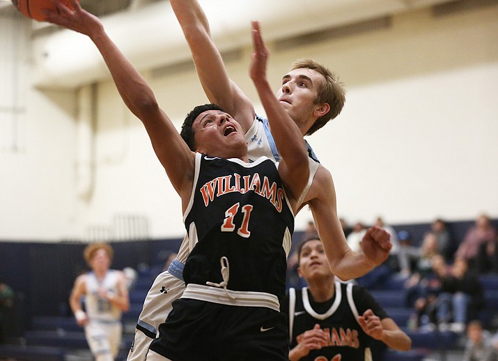 Kevin Nunez shoots the ball while fending off Veritas defense in Epic New Year's Classic in Chandler Dec. 30. (Marilyn R. Sheldon/WGCN)