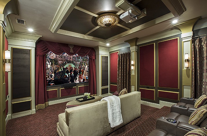 This image provided by John McClain Design shows a home theater with red velvet on the wall panels. The 'champagne-hued velvet' is on the big couch in foreground. For an Orlando, FL project, designer John McClain and his client wanted to evoke an Art Deco aesthetic, yet still design a functional state-of-the-art home theater. "We upholstered portions of the walls with red velvet inside of wooden accent panels to gain the hard-to-soft-surface-ratio that would normally be accomplished with acoustical panels or wall covering." Champagne-hued velvet seating completes the elegant, comfortable look. (John McClain Design and Zeke Ruelas/AP)