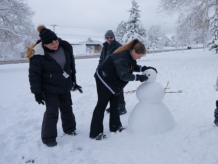The Immings family from Phoenix visit Williams to partake in snowy fun. The family spent their day building a snowman and walking around town. (Summer Serino/WGCN)