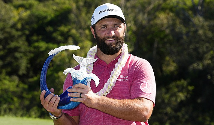 Scottsdale resident Jon Rahm, of Spain, holds the champions trophy after the final round of the Tournament of Champions golf event, Sunday, Jan. 8, 2023, at Kapalua Plantation Course in Kapalua, Hawaii. (AP Photo/Matt York)