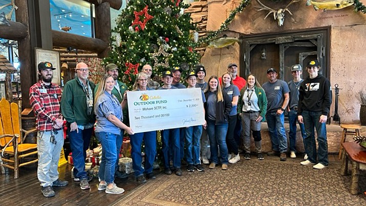 Members of the Kingman Mohave Top Guns Youth Shotgun Club recently received a $2,000 donation. Club members and leaders are pictured posing with the check.  (Courtesy photo)