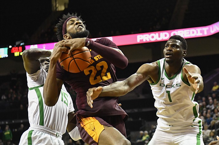 Arizona State forward Warren Washington (22) hauls in a rebound over Oregon forward Lok Wur (15) and center N'Faly Dante (1) during the first half of a game Thursday, Jan. 12, 2023, in Eugene, Ore. (Andy Nelson/AP)