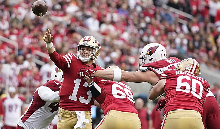 San Francisco 49ers quarterback Brock Purdy (13) throws a touchdown pass during the first half of an NFL football game against the Arizona Cardinals in Santa Clara, Calif., Sunday, Jan. 8, 2023. (AP Photo/Godofredo A. Vásquez)