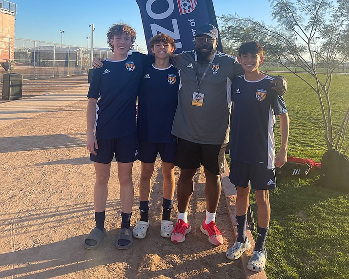 Cole Schumann, left, Roman DeWeese, middle left, and Rico Gutierrez, right, stand with Prescott-based ODP coach Phil Reid, middle right, after performing well at the US Youth Soccer’s Olympic Development Program Far West Regional Championships from Jan. 6 to 9, 2023, in Mesa. (Phil Reid/Courtesy)