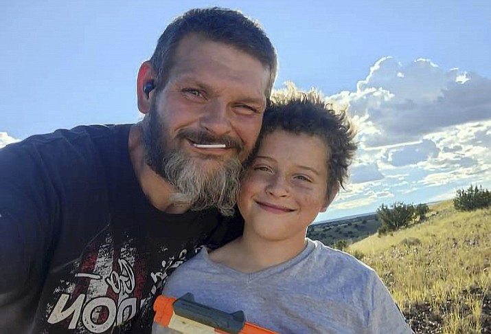 This 2022 photo provided by Richard Blodgett shows Blodgett and his son, Jakob. Blodgett was arrested in December, and Jakob was placed in a foster home under the Arizona Department of Child Safety where he developed complications from diabetes and died. (Richard Blodgett via AP)