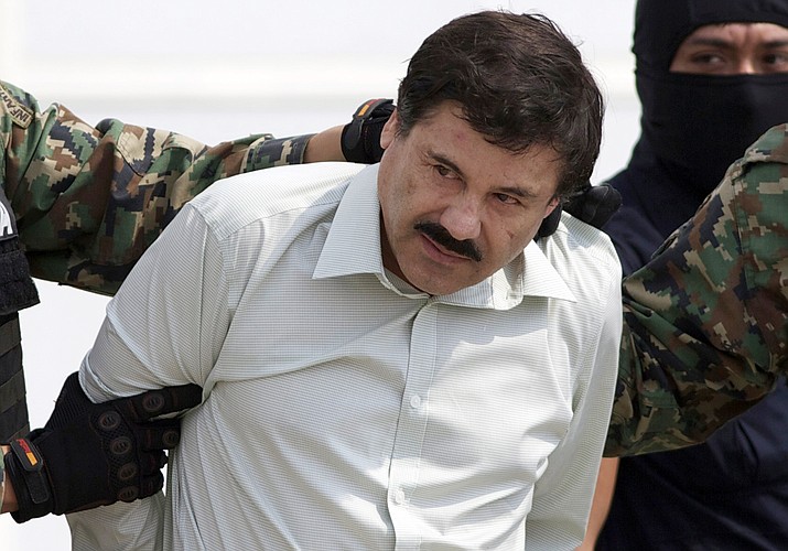In this Feb. 22, 2014 file photo, Joaquin "El Chapo" Guzman, the head of Mexico's Sinaloa Cartel, is escorted to a helicopter in Mexico City following his capture in the beach resort town of Mazatlan, Mexico. Mexican President Andrés Manuel López Obrador said on Wednesday, Jan. 18 2023 that the government will analyze El Chapo's request to be returned to Mexico to carry out his life prison sentence. (Eduardo Verdugo/AP, File)