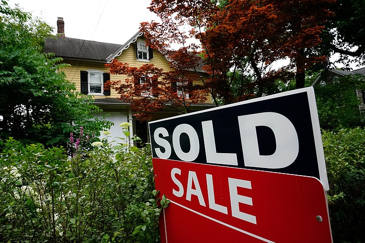 A sale sign stands outside a home in Wyndmoor, Pa., Wednesday, June 22, 2022. On Friday, the National Association of Realtors reports on sales of existing homes in December. (Matt Rourke/AP, File)