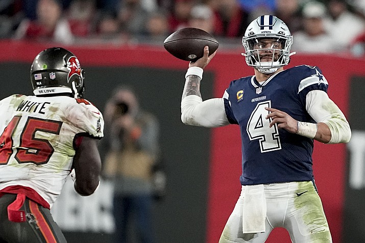 Dallas Cowboys quarterback Dak Prescott (4) passes in the pocket as Tampa Bay Buccaneers linebacker Devin White (45) drives in during the second half of a wild-card game, Monday, Jan. 16, 2023, in Tampa, Fla. (Chris Carlson/AP)