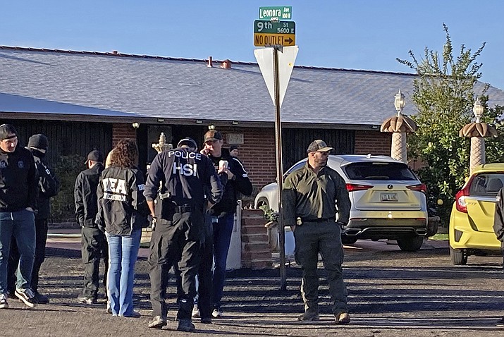 Law enforcement personnel stand outside at a home in Tucson, Ariz. U.S. agents in southern Arizona said they seized up to 440 pounds of what they suspect is a precursor chemical often used to manufacture the dangerous drug fentanyl. (Photo/Associated Press)