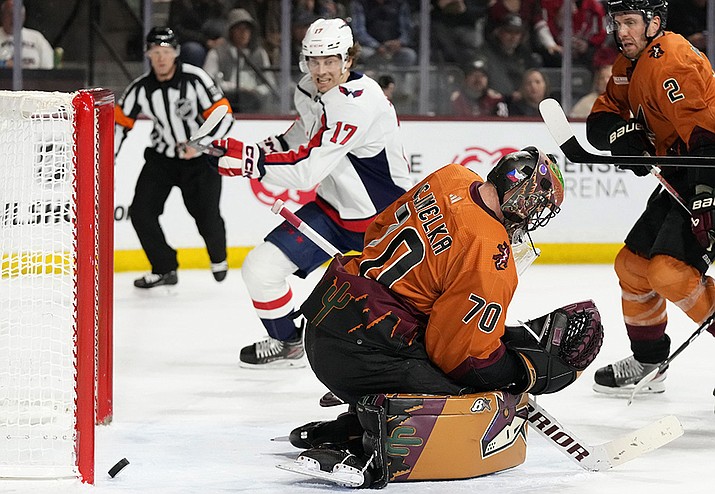 Arizona Coyotes goaltender Karel Vejmelka (70) gives up a goal to Washington Capitals' Tom Wilson (not shown) as Capitals center Dylan Strome (17) and Coyotes defenseman Patrik Nemeth (2) look on during the second period of an NHL hockey game in Tempe, Ariz., Thursday, Jan. 19, 2023. (Ross D. Franklin/AP)