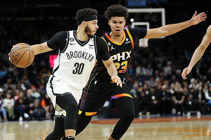 Brooklyn Nets guard Seth Curry (30) drives as Phoenix Suns forward Cameron Johnson (23) defends during the first half of an NBA basketball game, Thursday, Jan. 19, 2023, in Phoenix. (Matt York/AP)