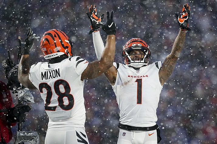 Cincinnati Bengals wide receiver Ja'Marr Chase (1) and Cincinnati Bengals running back Joe Mixon (28) motion for a touchdown against the Buffalo Bills during the third quarter of an NFL division round football game, Sunday, Jan. 22, 2023, in Orchard Park, N.Y. (Joshua Bessex/AP)