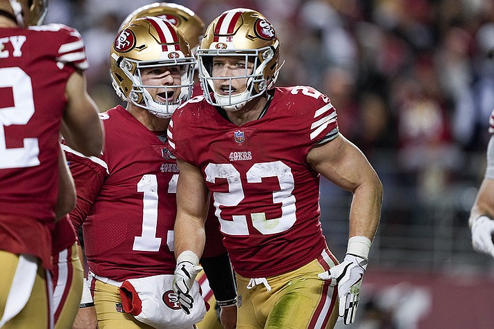 San Francisco 49ers running back Christian McCaffrey (23) celebrates after scoring a touchdown with quarterback Brock Purdy during the second half of an NFL divisional round playoff football game against the Dallas Cowboys in Santa Clara, Calif., Sunday, Jan. 22, 2023. (Tony Avelar/AP)