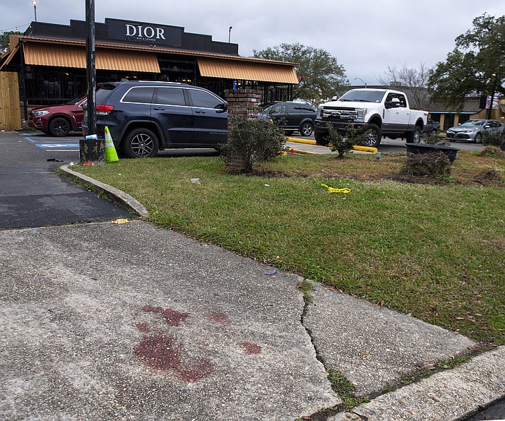 Blood stains and a small section of police tape show the scene where multiple people were injured following an overnight shooting at the Dior Bar & Lounge in Baton Rouge, La., on Sunday, Jan. 22, 2023. (Michael Johnson/The Advocate via AP)