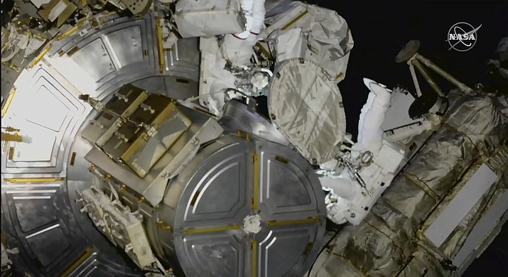 This photo provided by NASA, astronauts NASA's Nicole Mann and Japan's Koichi Wakata venture out on a spacewalk at the International Space Station on Friday, Jan. 20, 2023. Their job was to install support struts for small solar panels launching this summer, part of a continuing effort by NASA to expand the space station's power grid. (NASA via AP)