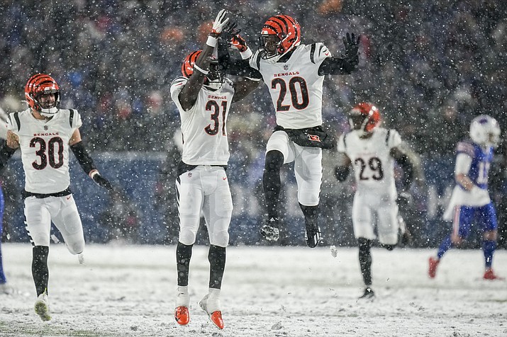 Cincinnati Bengals safety Michael Thomas (31) and Cincinnati Bengals cornerback Eli Apple (20) react after a defensive play against the Buffalo Bills during the fourth quarter of a division round game, Sunday, Jan. 22, 2023, in Orchard Park, N.Y. (Seth Wenig/AP)