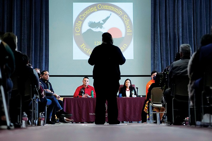 U.S. Interior Secretary Deb Haaland, right, and Assistant Secretary for Indian Affairs Bryan Newland, left, listen as April Hiosik Ignacio, center, speaks of her grandmother's time in an Indian boarding school during a "Road to Healing" event, Friday, Jan. 20, 2023, at the Gila Crossing Community School in Laveen, Ariz. The "The Road to Healing," is a year-long tour across the country to provide Indigenous survivors of the federal Indian boarding school system and their descendants an opportunity to share their experiences. (AP Photo/Matt York)
