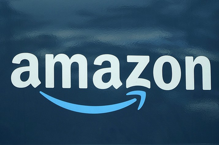An Amazon logo appears on a delivery van, Oct. 1, 2020, in Boston. Amazon is adding a prescription drug discount program to its growing health care business. The retail giant said Tuesday that it will launch RxPass, a subscription service for customers who have Prime memberships. (Steven Senne/AP, File)