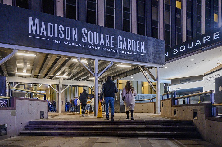 Fans line up outside Madison Square Garden before an NBA basketball game between the New York Knicks and the Golden State Warriors in New York, Feb. 23, 2021. New York City’s Madison Square Garden and other sports venues would be barred from refusing entry to perceived enemies of their owners under a bill introduced to the state Legislature Monday, Jan. 23, 2023. (Brittainy Newman/AP, File)