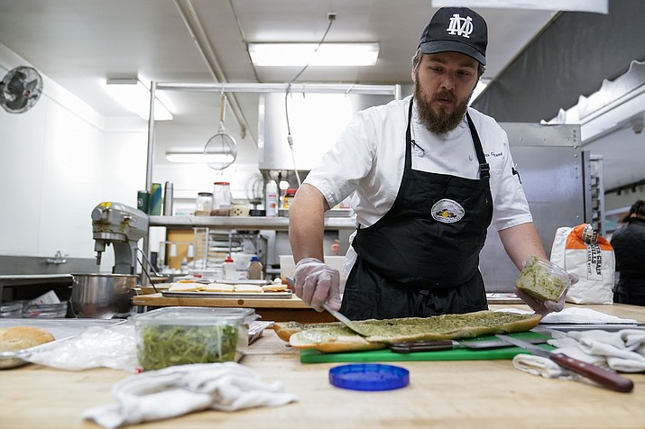 Chef Josh Gjersand prepares a sandwich for Mount Diablo High School students to try during a taste test in Concord, Calif., Friday, Jan. 13, 2023. The school district in suburban San Francisco has been part of a national "farm-to-school" movement for years, where schools try to buy as much locally as possible. But the mission has been kicked into higher gear with a California program that provides free meals to all public school students in the state, along with unprecedented new funding. (Godofredo A. Vásquez/AP)