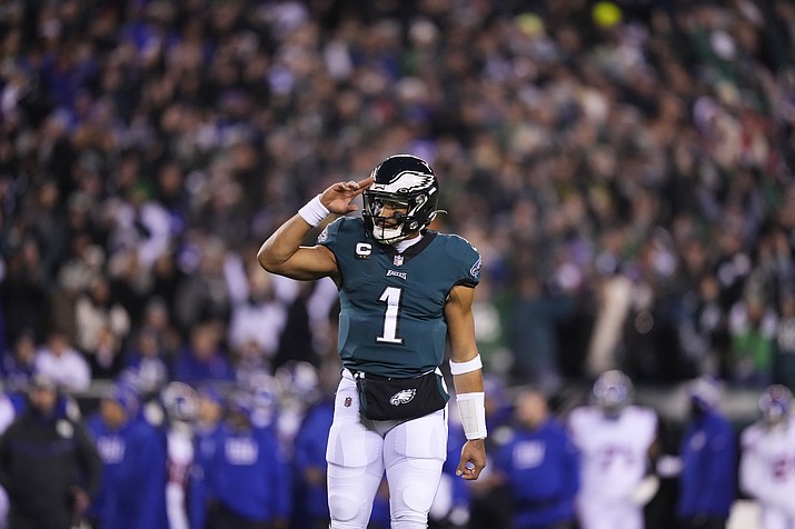 Philadelphia Eagles quarterback Jalen Hurts reacts after throwing a touchdown pass to wide receiver DeVonta Smith during the first half of a divisional round playoff game against the New York Giants, Saturday, Jan. 21, 2023, in Philadelphia. (Matt Slocum/AP)