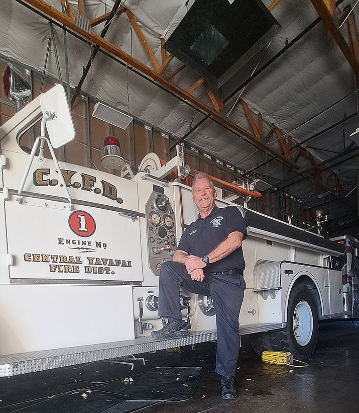 Central Arizona Fire and Medical Authority (CAFMA) Fire Marshal Rick Chase stands next to a 1954 Seagraves fire engine. (Debra Winters/Courier)