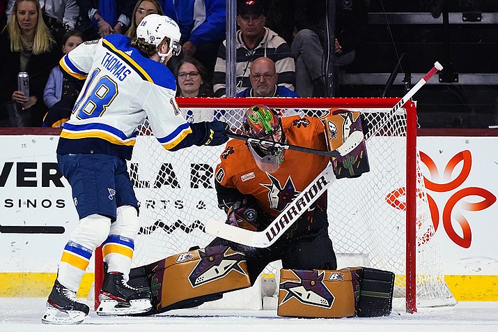 Arizona Coyotes goaltender Karel Vejmelka, right, makes a save on a shot by St. Louis Blues center Robert Thomas (18) during the first period of an NHL hockey game in Tempe, Ariz., Thursday, Jan. 26, 2023. (Ross D. Franklin/AP)