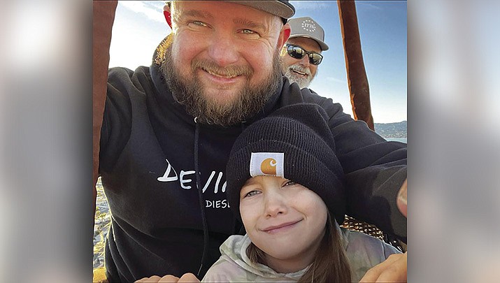 Matt Farris is pictured with his daughter Scarlett during their first hot air balloon trip. It was a pleasant trip until the end, when a gust of wind blew the balloon into powerlines. (Photo courtesy of Matt Farris’ Facebook page)