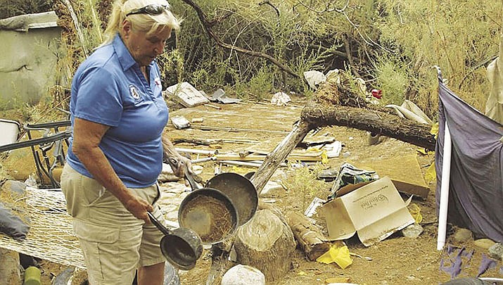 Veterans United Arizona President Frankie Lyons investigates an abandoned homeless camp at Body Beach in this file photo. (River City News Service file photo)