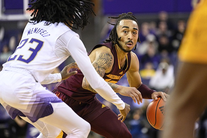 Arizona State's Frankie Collins (10) dribbles the basketball against Washington's Keyon Menifield (23) during overtime of an NCAA game Thursday, Jan. 26, 2023, in Seattle. (Caean Couto/AP)