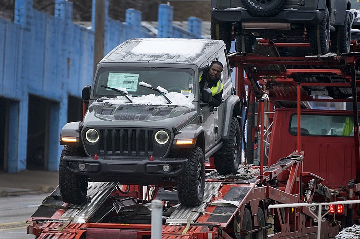 A new Jeep is delivered to a dealership in Pittsburgh on Monday, Jan. 23, 2023. The Federal Reserve’s preferred inflation gauge eased further in December, and consumer spending fell. (Gene J. Puskar/AP)