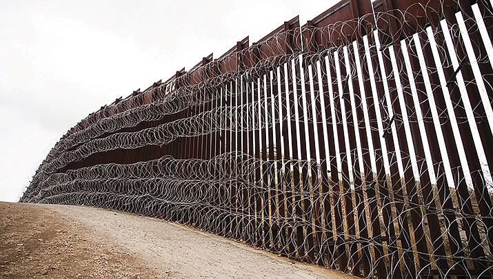 The new online system for seeking asylum in the United States has been overwhelmed by a large number of requests. A section of border wall is pictured. (Adobe image)