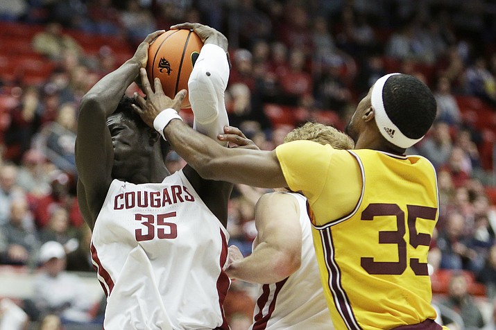 Washington State forward Mouhamed Gueye, left, grabs a rebound next to Arizona State guard Devan Cambridge during the second half of a NCAA game, Saturday, Jan. 28, 2023, in Pullman, Wash. (Young Kwak/AP)