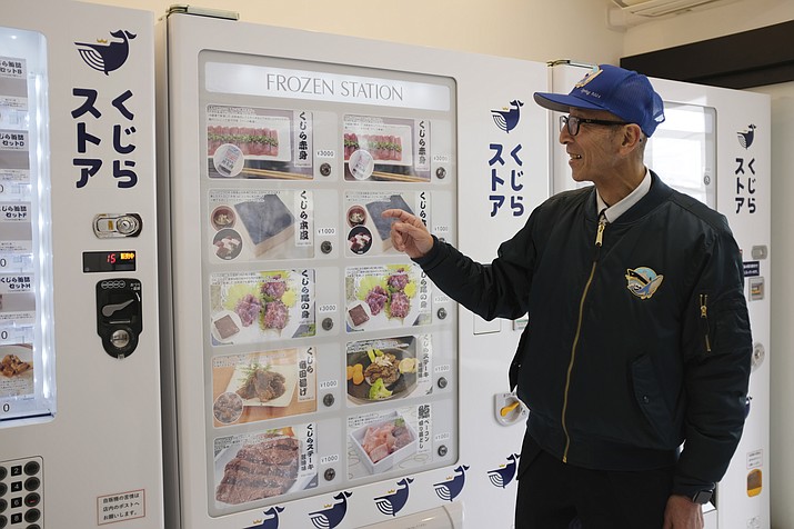 Konomu Kubo, a spokesperson for Kyodo Senpaku Co. explains how whale meat is being sold from a vending machine at the firm’s store, Thursday, Jan. 26, 2023, in Yokohama, Japan. The Japanese whaling operator, after struggling for years to promote its controversial products, has found a new way to cultivate clientele and bolster sales: whale meat vending machines. (Kwiyeon Ha/AP)