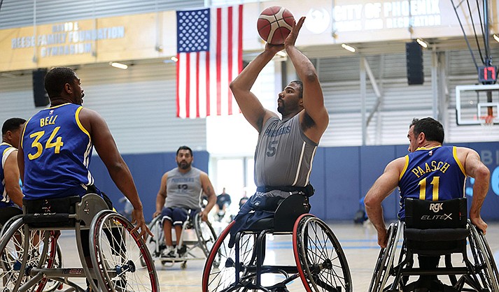 Trevon Jenifer of the MedStar NRH Punishers takes a shot while surrounded by Golden State Road Warriors defenders at the 23rd annual D1 Phoenix Invitational at Ability360 in Phoenix Jan. 28, 2023. (Photo by Brooklyn Hall/Cronkite News)
