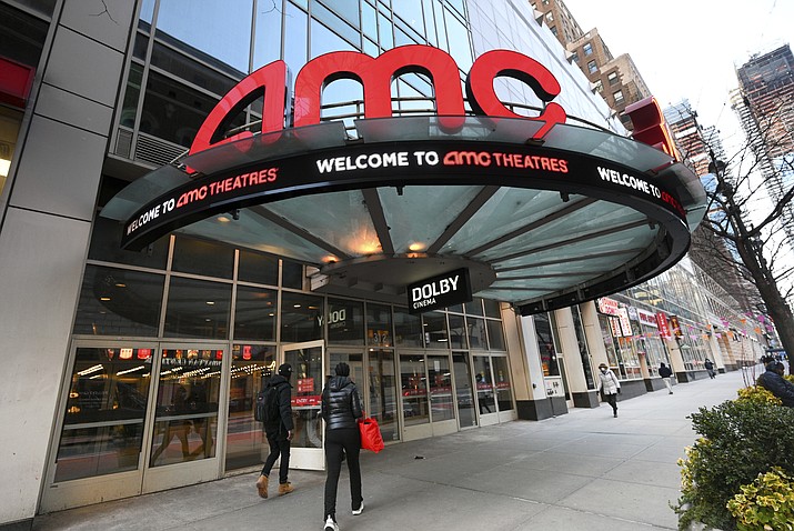 People walk by the AMC 34th Street theater on March 5, 2021, in New York. AMC Theaters, the nation's largest movie theater chain, on Monday unveiled a new pricing scheme in which seat location determines how much your movie ticket costs. Seats in the middle will cost a dollar or two more, while seats in the front row will be slightly cheaper. (Evan Agostini/Invision/AP, File)
