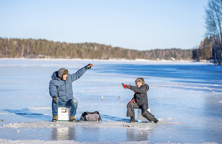 There are several icy lakes in Williams for anyone interested in ice fishing. (Photo/Adobe Stock)