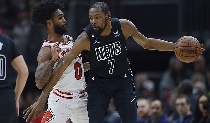 Brooklyn Nets' Kevin Durant (7) looks to drive against Chicago Bulls' Coby White (0) during the second half of an NBA basketball game Wednesday, Jan. 4, 2023, in Chicago. (AP Photo/Paul Beaty, File)